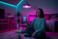 Person controlling smart RGB bulb colour via smartphone app